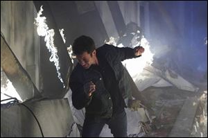 Kirk Cameron, starring as reporter Buck Williams, escapes from a burning building as World War III breaks out in a scene from the movie Left Behind: World at War.