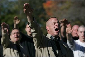 A member of the National Socialist Movement confronts protesters on Stickney Avenue on the grounds of Woodward High School in Toledo.