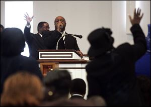 The Rev. John W. Williams emphasizes the strength of Jesus, obedience of children, and the need to fight hate with love during services at Eastern Star Missionary Baptist Church in Toledo.