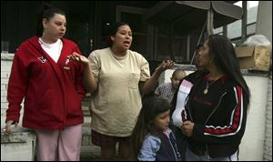 Mulberry Street residents, from left, Annette Mendoza, Elizabeth Montoya, an unidentified child, Elaina Ortiz, and her mom, Jamie Ortiz, discuss the riot. In front is Catalina Montoya, 5. 