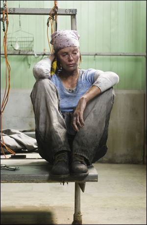 Josey Aimes (Charlize Theron) faces rough treatment when she takes a job in a mine.