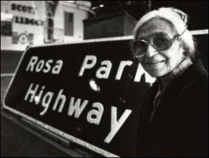 Rosa Parks stands next to a sign at Scott High School in Toledo
in 1990. Part of I-475 is designated as Rosa Parks Highway.
