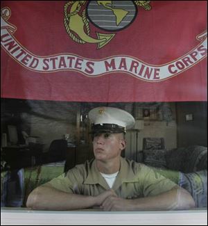 Lance Cpl. Ian Mikolajczak proudly displays a Marine Corps flag in the front window of his family's home on Schneider Road. 
The Iraq war veteran is a graduate of Bowsher High School.