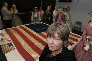Textile conservationist Jane Hammond spent 400 hours restoring the 34-star flag once carried by the 21st Ohio Infantry. It will soon be displayed at the Hancock Historical Museum.