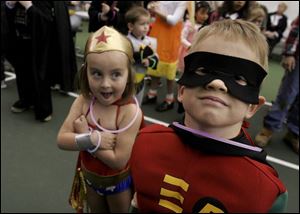 SIDEKICKS?: At left, Megan Radeloff and Connor Bishop take time out from saving the world to pose at the Belmont Country Club event.