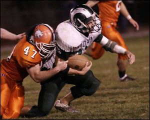 Southview's Sean Cardone tackles Mansfield Madison's Seth Stringer in the third quarter last night at Cats Stadium.