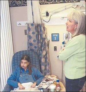 Angie Mitchell and her mother, Linda, visit at the Pittsburgh hospital where she had transplant surgery in September.