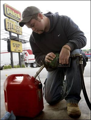 Rob Failor of Pemberville, Ohio, fills a can with gas that is priced at $2.04 a gallon at the Pilot Travel Center on I-280 in Stony Ridge.
