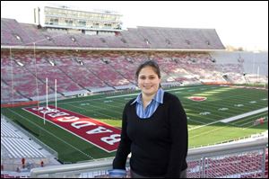 Defiance native Katharine Palmer, who formerly worked with the football program at Ohio State, is impressed with Wisconsin's Camp Randall Stadium and coach Barry Alvarez.