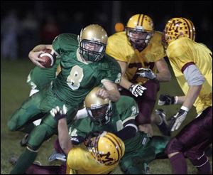 St. Mary Catholic Central s Thomas Lieto picks up a first down against Manchester. He gained 185 yards and scored three TDs.