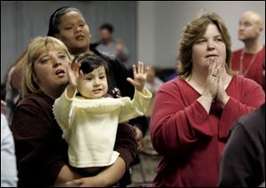 From left, Cheryl Sherman, Peggy Hydlebeerd, 2-year-old Alexia Handy, and Linda Jones clap along with the music.