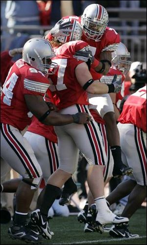 Ohio State linebacker A.J. Hawk is mobbed by teammates after returning a blocked punt for a touchdown in a win over Northwestern.