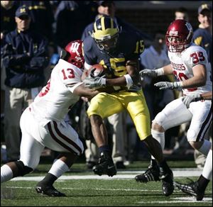 Michigan's Steve Breaston tries to get past Indiana's Andrew Means (13). Breaston had 201 all-purpose yards against the Hoosiers to help keep the Wolverines' hopes for a share of the conference title alive.