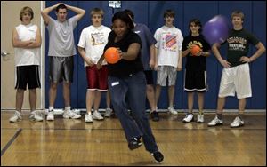 Scott High School senior Tianna Dandridge plays kickball with students from Clyde High School in a gym class during a cultural exchange program at the Sandusky County school.
