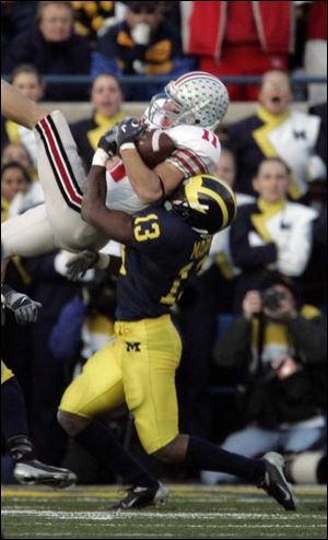 Ohio State wide receiver Anthony Gonzalez goes high against Michigan defensive back Grant Mason to come up with a vital reception to set up the winning touchdown for the Buckeyes late in the fourth quarter.