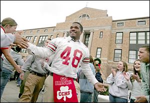 Slug: CTY central02p             Date:   12.02.05        The Blade/Madalyn Ruggiero      Location:  Central Catholic, Toledo, o  Caption:     Central Catholic football player AaronPeterson a junior   at   is mobbed by students while heading to the bus at Central Catholic Friday morning 12.2.05 just before heading to Division  11 finals tonight.