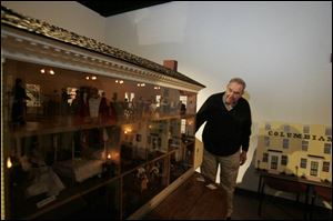 Clayton 'Bud' Ziegler looks at the 1/12-scale Columbian House model he and his wife built.