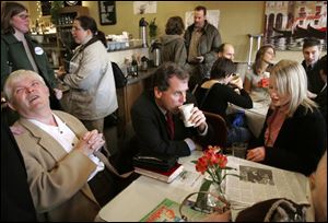 Sherrod Brown has a cup of coffee yesterday as he talks with voters during a stop at Toledo's Downtown Latte to kick off his campaign for U.S. Senate. Schuyler Beckwith, right, and Al Baldwin share a table with the candidate.
