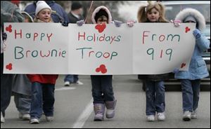 Brownies from Troop 919 joined other groups, Shriners, and floats in the East Toledo parade.