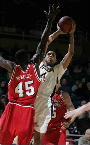 Toledo's Jonathan Amos goes up for a shot against Northern Illinois defender Bryson McKenzie in the first half.