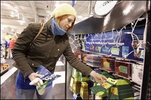 Jennifer Dewar, of Perrysburg, selects from the gift cards on display at Best Buy on Monroe Street in Toledo.