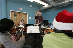 Virgil Lupo conducts a class at Toledo School for the Arts with Richard Goss, left; Kelsey Isaacs, at rear, and Chafika Simmons. TSA is Lucas County's top academically rated charter school.