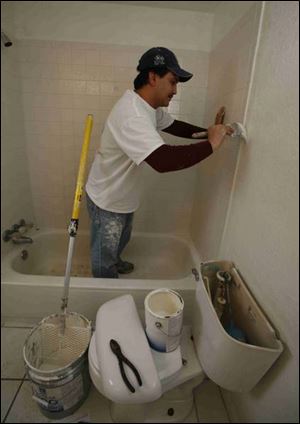 Daniel Boyle paints a bathroom in the house.
