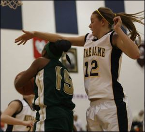 Notre Dame's Kristen Kerscher tries to block a shot attempt by Start's Keaira Marsenburg last night. Marsenburg led the Spartans with 19 points while Kerscher scored eight points and hauled down 11 rebounds for the Eagles, who improved to 8-3 overall and 4-2 in the City League.
