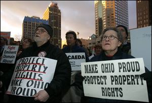 Albert and Barbara Miller of Lakewood, Ohio, join about 50 people in Columbus at a rally for private property rights. 