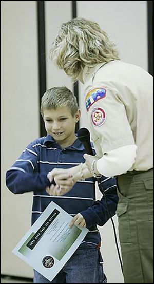 Ben Petro receives a Good Turn for America award presented by the Boy Scouts of America.
