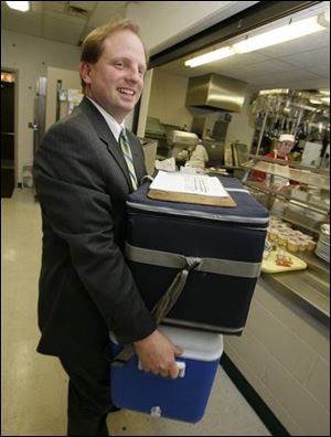 City Prosecutor Matthew Reger is active in many community efforts, including delivering meals to senior citizens.