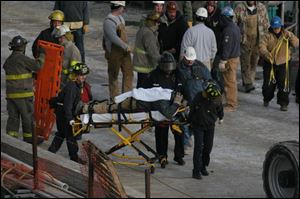 An emergency crew removes an injured worker from the I-280 bridge construction area.