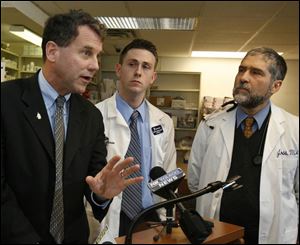 U.S. Rep. Sherrod Brown, a Democratic candidate for the Senate, speaks out against the new Medicare drug plan with pharmacist Bryan Coehrs and Dr. Johnathon Ross.