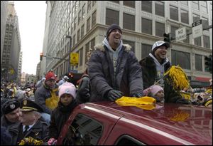 Ben Roethlisberger, left, rides in the parade with backup quarterback Charlie Batch. 'Thank you guys so much,' Roethlisberger told the crowd. 'This has been a dream come true for all of us.'