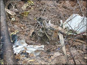 The wreckage of a turboprop
cargo plane flying from Ohio to Texas is scattered in a wooded area of Tennessee after a crash yesterday that killed pilot Abdulgader Zbedah of Louisville. The plane dove nose down, burrowing 10 to 15 feet into the ground, a sheriff s office spokesman said.
