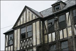 Many windows are broken out on the upper floors of the Ira Apartments on Parkside Blvd. at Dorr St. 