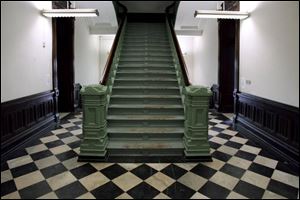 A grand staircase leads upstairs from the first-floor hallway inside the Seneca County Courthouse in Tiffin, Ohio. 