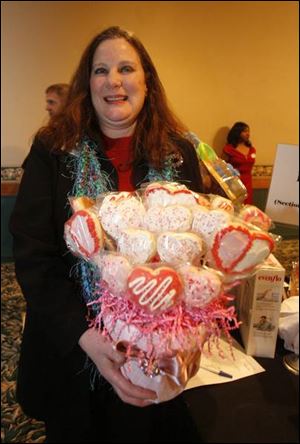 SWEET HEART: Eileen Walsh poses with a basket of cookies. The basket was a sweet prize for the winner of an auction during the Heart Association gala at Gladieux Meadows.
