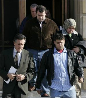 Attorney Charles Sallah escorts family members of Wassim Mazloum from the federal courthouse yesterday.