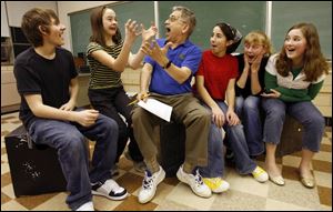 F. Scott Regan, center, who is directing his 100th play, works with, from left, Ahmad Ghadban, 16, Naomi Sinn, 11, Layan Elwazani, 12, Darien Ankney, 12, and Rachel Rine, 12, during rehearsal for 