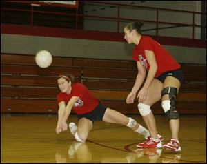 Lexi Leonhard reaches for the ball as Tara Breske move in during practice.