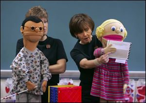 Kay Barbour, left, and Brenda Engle use puppets to teach students in Waterville Elementary School about mental and physical handicaps and how to accept them.