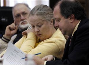 Michael and Sharen Gravelle, from left, confer with attorney Ken Myers during a court hearing yesterday in Norwalk.