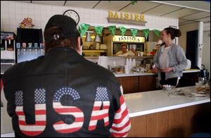 A patriotic local resident takes a seat at the counter of Daisies Cafe in Lackawanna. Some of the men convicted in the terrorism case frequented the diner, a waitress recalled.
