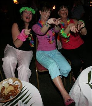 SEAT BEAT: Colleen Lishewski, left, Angela Roether, and Teri Tarquinio don't let their seats stop them from moving their feet at the Toledo Club's Summer Fling.