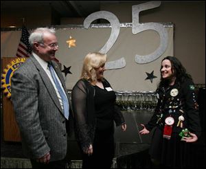 25-PLUS: Bob Adams, left, and Julie Oswald chat with Isa Freitas, a Brazilian exchange student.