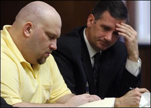 Jeffrey Zenowicz, left, and one of his attorneys, Jeff Helmick, listen to evidence at Mr. Zenowicz's trial.