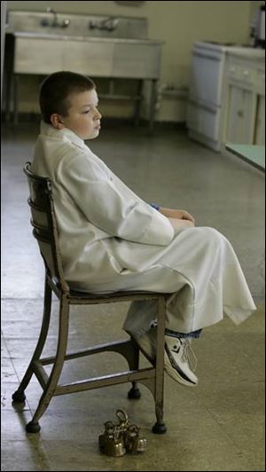 Father Nowak's son, Jacob, 10, photo right, serves as an altar boy during yesterday's service.