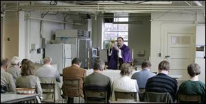 The Rev. Jaroslaw Nowak of Hamtramck, Mich., says Mass for a group of disaffected Catholics at a service in the Common Space Center for Creativity. Father Nowak is with the Polish National Catholic Church, which recognizes married priests. 