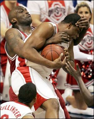 Indiana's Marco Killingsworth, left, gets physical with Ohio State's Terence Dials in the middle.